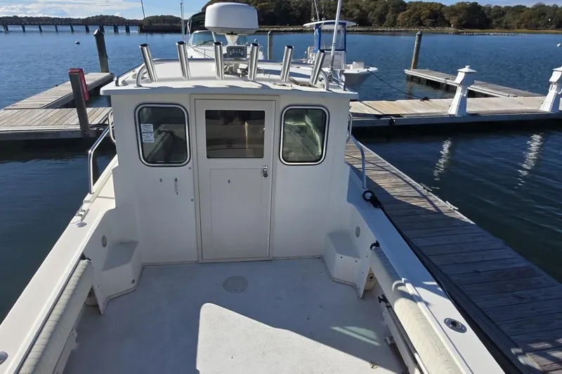 Slide: The Image of 2007 Parker 2320 SL Sport Cabin boat docked at marina with Garmin equipment. - 3