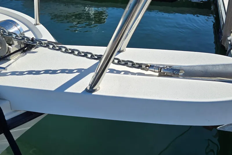 Slide: The Image of Anchor chain on 2007 Parker 2320 SL Sport Cabin boat deck by water. - 8