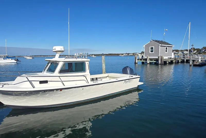 Slide: The Image of 2007 Parker 2320 SL Sport Cabin boat docked in a serene harbor setting. - 9