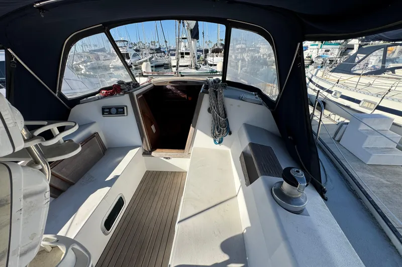 Slide: The Image of Cockpit view of a 1989 Catalina 42 sailboat docked at a marina. - 10