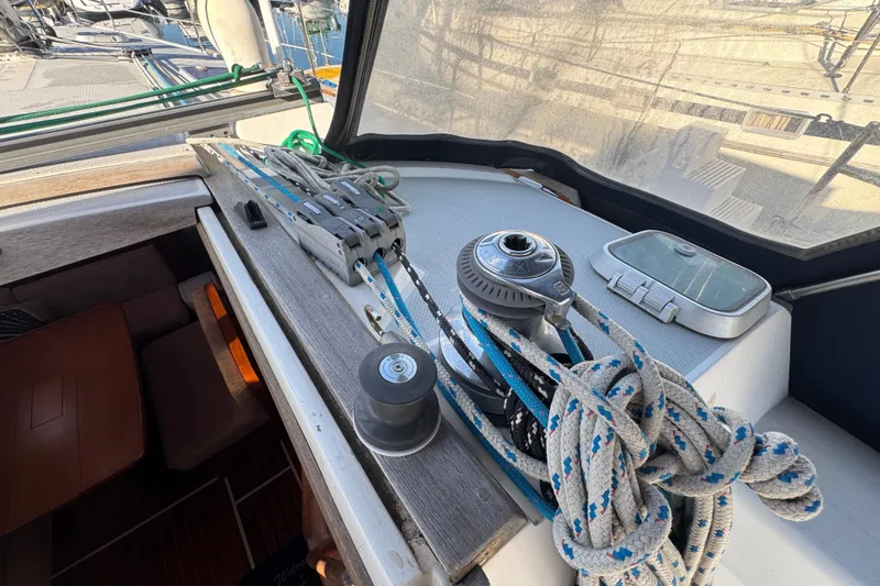 Slide: The Image of Sailing equipment on a 1989 Catalina 42 yacht, featuring ropes and winch in the cockpit. - 13