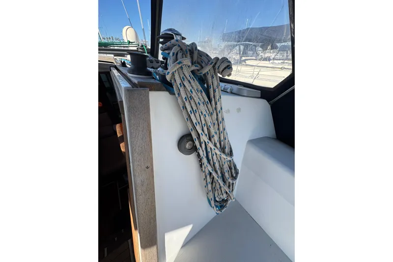 Slide: The Image of Coiled rope on 1989 Catalina 42 sailboat deck, with marina view. - 14