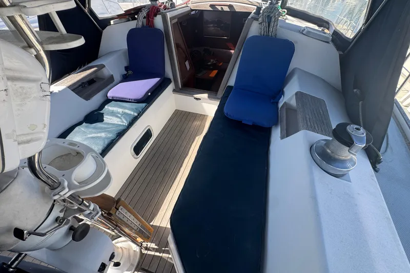 Slide: The Image of Cockpit of 1989 Catalina 42 sailboat with cushioned seating and winch. - 16