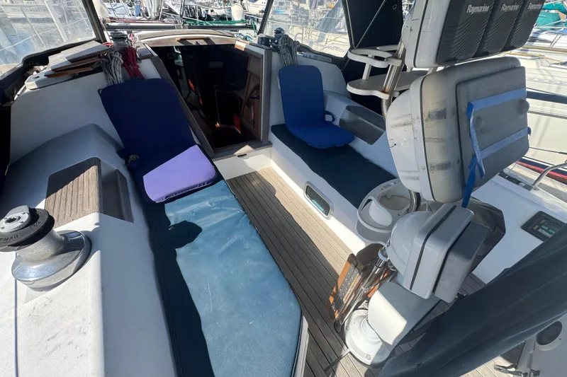 Slide: The Image of Cockpit of a 1989 Catalina 42 sailboat with seating and navigation equipment. - 17