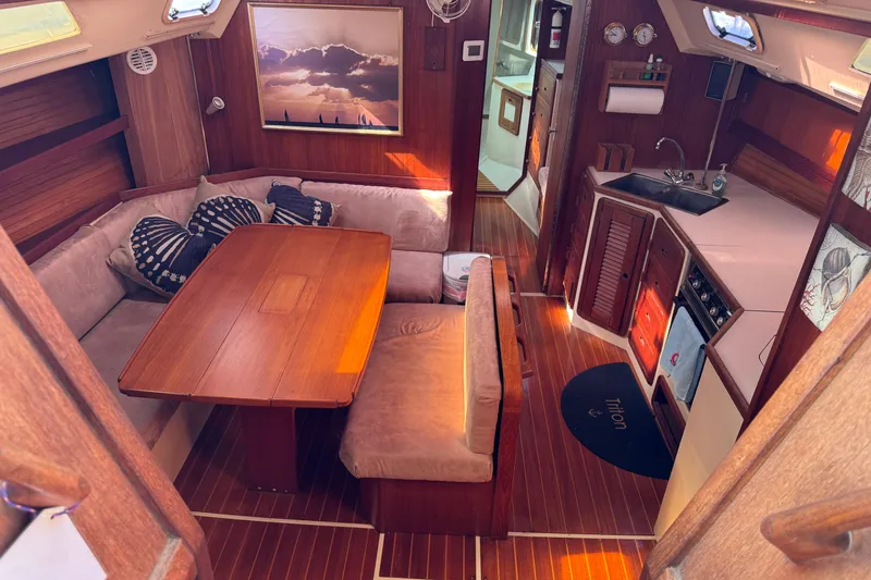 Slide: The Image of Interior of a 1989 Catalina 42 sailboat with cozy seating and wooden finishes. - 19
