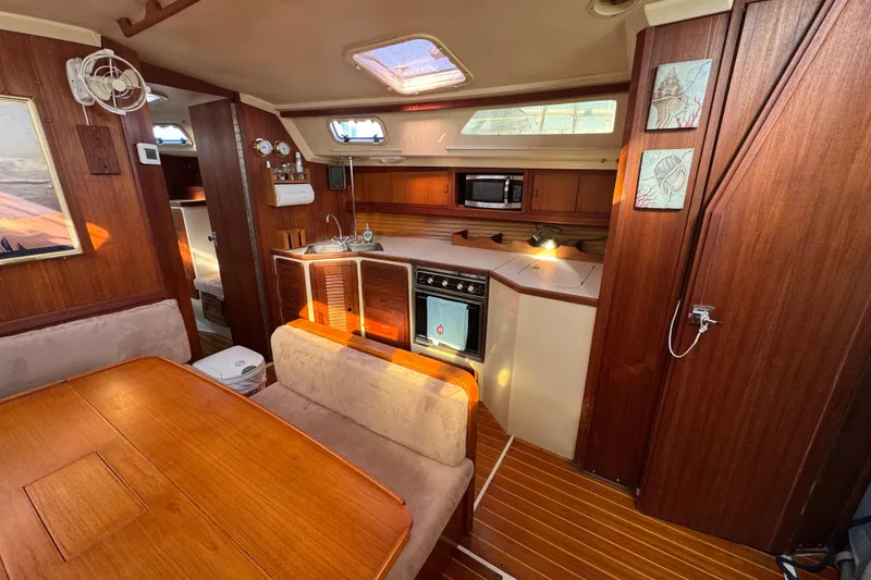 Slide: The Image of Interior of a 1989 Catalina 42 sailboat with wood finishes and compact kitchen. - 28