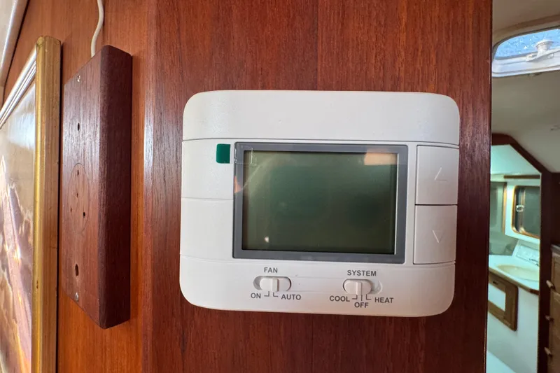 Slide: The Image of Thermostat on wooden panel inside 1989 Catalina 42 yacht cabin. - 29