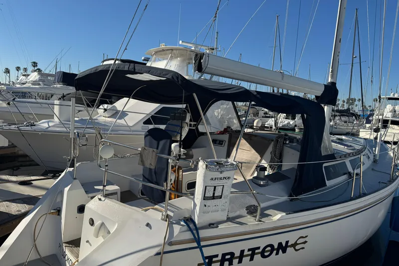 Slide: The Image of Catalina 42 sailboat from 1989 docked at a marina under clear blue skies. - 3