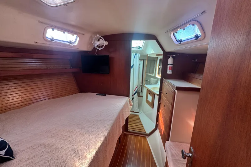 Slide: The Image of Interior of 1989 Catalina 42 sailboat cabin with bed, TV, and bathroom. - 30