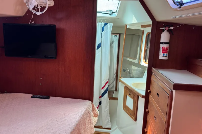Slide: The Image of Interior of 1989 Catalina 42 yacht with bed, TV, and bathroom. - 31