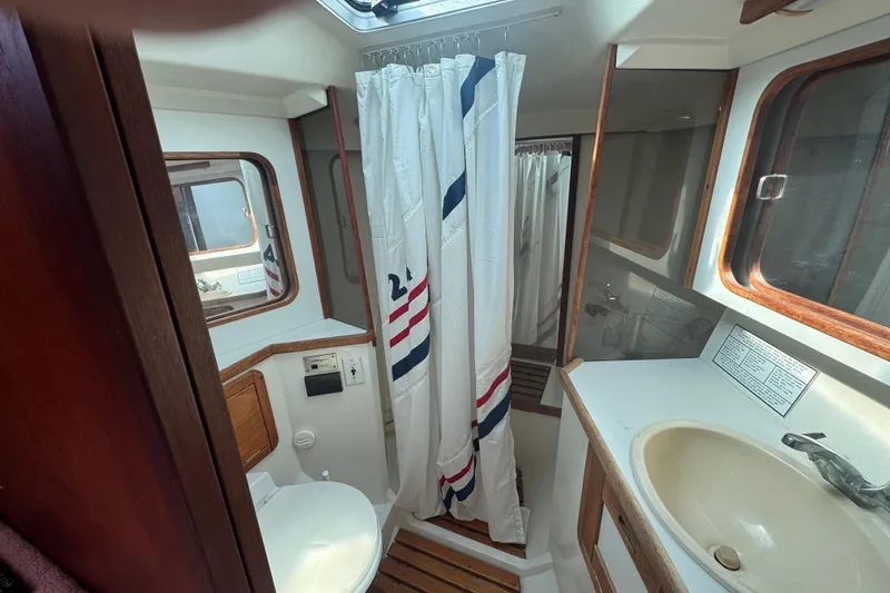 Slide: The Image of Bathroom interior of a 1989 Catalina 42 sailboat with shower and sink. - 32