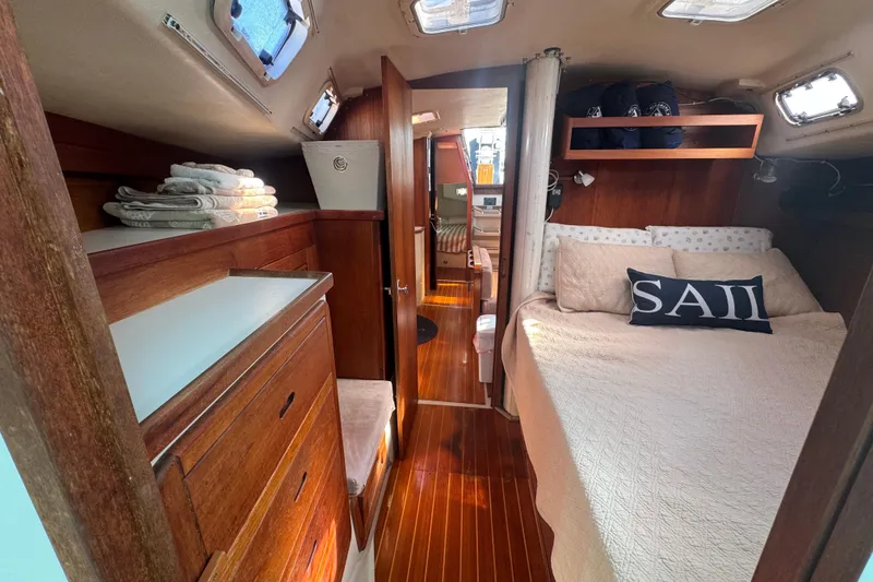Slide: The Image of Cozy interior of 1989 Catalina 42 sailboat with wood finish and comfortable bedding. - 33