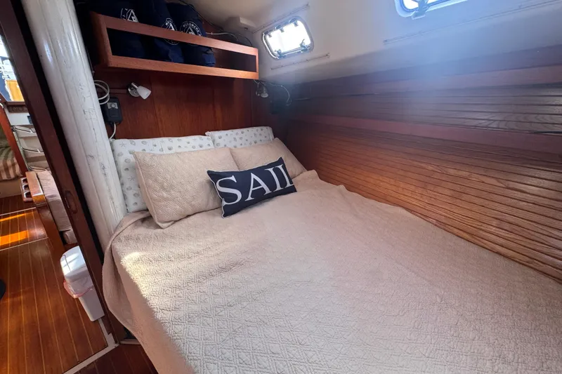 Slide: The Image of Cozy cabin interior of 1989 Catalina 42 sailboat with comfortable bedding and nautical decor. - 34