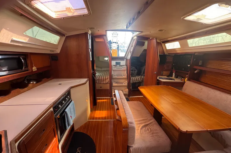 Slide: The Image of Interior of a 1989 Catalina 42 sailboat with dining area and kitchen. - 35