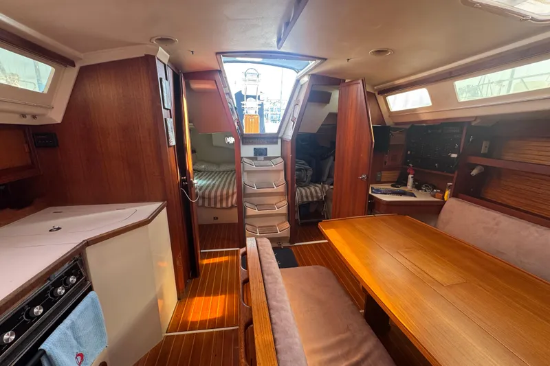 Slide: The Image of Interior of a 1989 Catalina 42 sailboat with wood finishes and cozy seating area. - 42