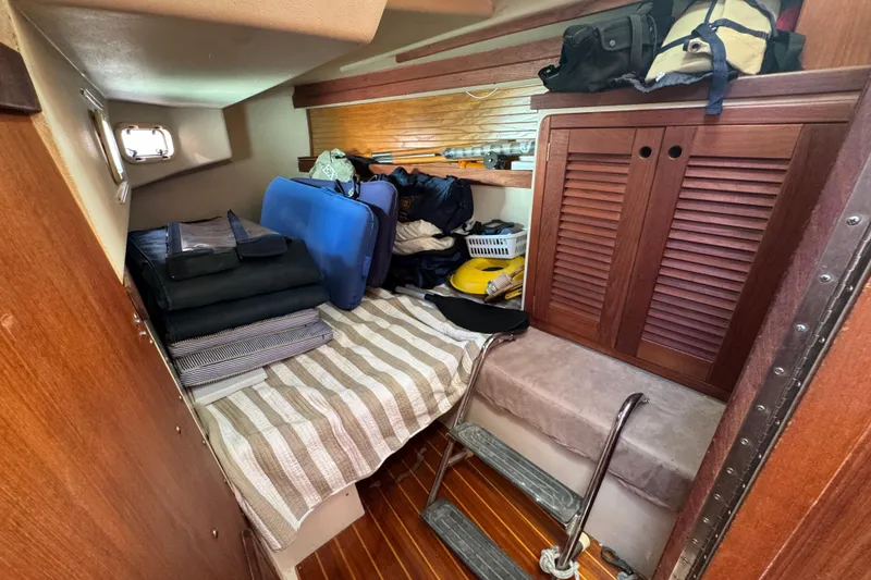 Slide: The Image of Cozy cabin interior of 1989 Catalina 42 sailboat with storage and bedding. - 46