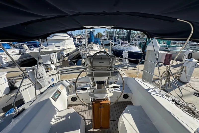Slide: The Image of Cockpit view of a 1989 Catalina 42 sailboat docked at a marina. - 49