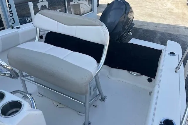Slide: The Image of 2014 Robalo R180 Center Console boat interior with seating and engine view. - 5
