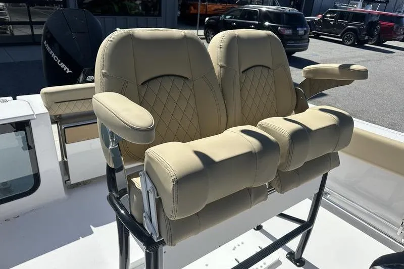 Slide: The Image of 2026 Sportsman Open 232 Center Console boat seats with beige upholstery and armrests. - 12