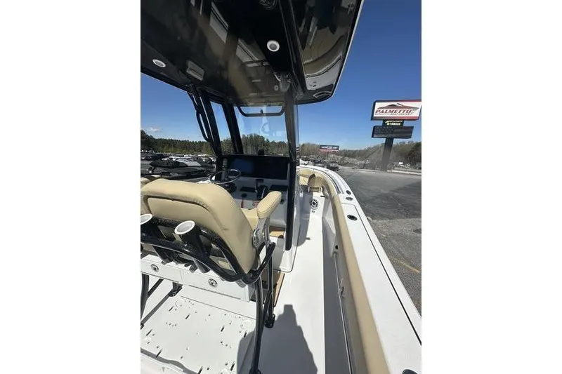 Slide: The Image of 2026 Sportsman Open 232 Center Console boat interior with beige seating and modern controls. - 13