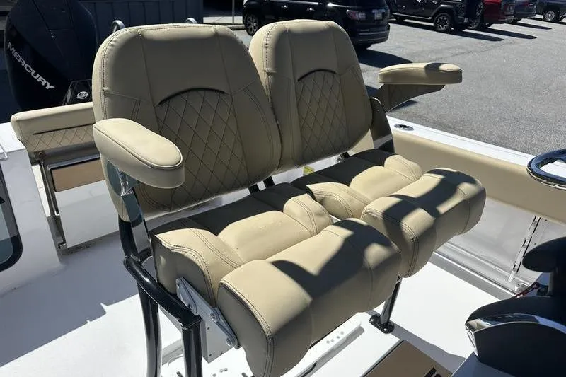 Slide: The Image of 2026 Sportsman Open 232 Center Console boat seats with beige upholstery and armrests. - 14