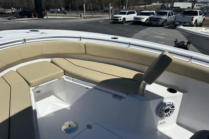 Slide: The Image of 2026 Sportsman Open 232 Center Console boat with beige seating and speaker system. - 15