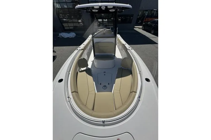 Slide: The Image of 2026 Sportsman Open 232 Center Console boat with tan seating and sleek design. - 16