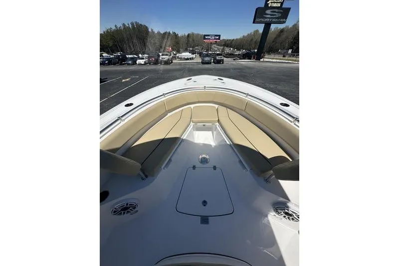 Slide: The Image of 2026 Sportsman Open 232 Center Console boat with tan seating, parked outdoors. - 18
