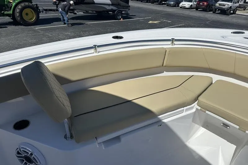 Slide: The Image of 2026 Sportsman Open 232 Center Console boat with beige seating in a parking lot. - 20