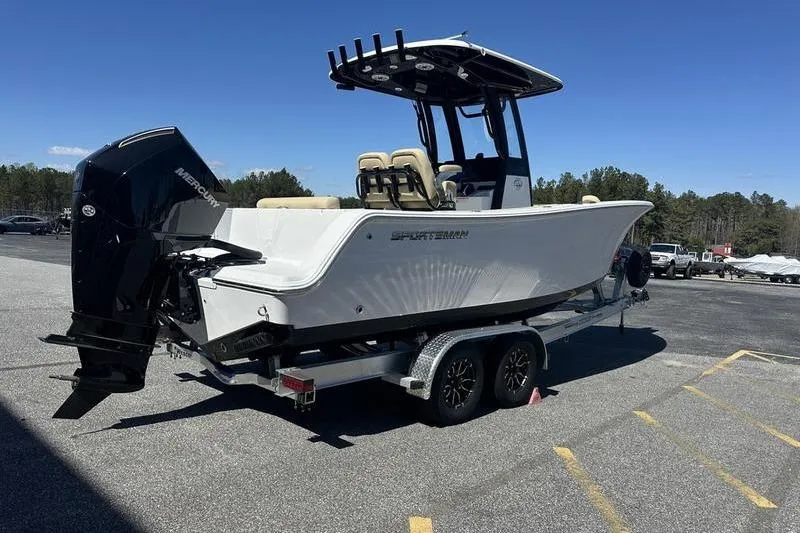 Slide: The Image of 2026 Sportsman Open 232 Center Console boat on trailer, parked outdoors. - 3
