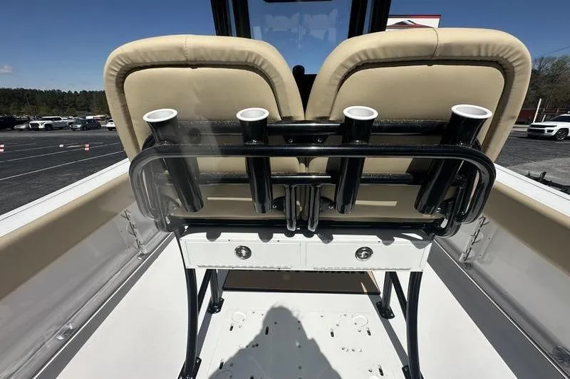 Slide: The Image of 2026 Sportsman Open 232 Center Console boat interior with rod holders and seating. - 4