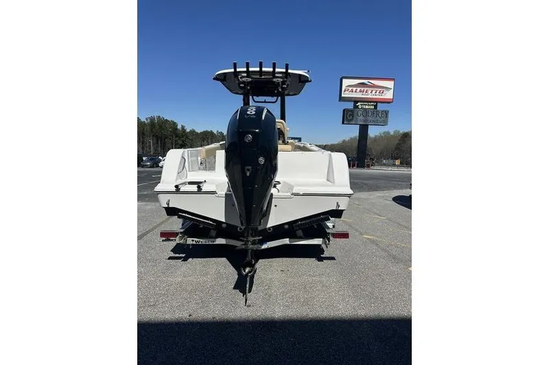 Slide: The Image of 2026 Sportsman Open 232 Center Console boat on trailer, rear view in parking lot. - 7