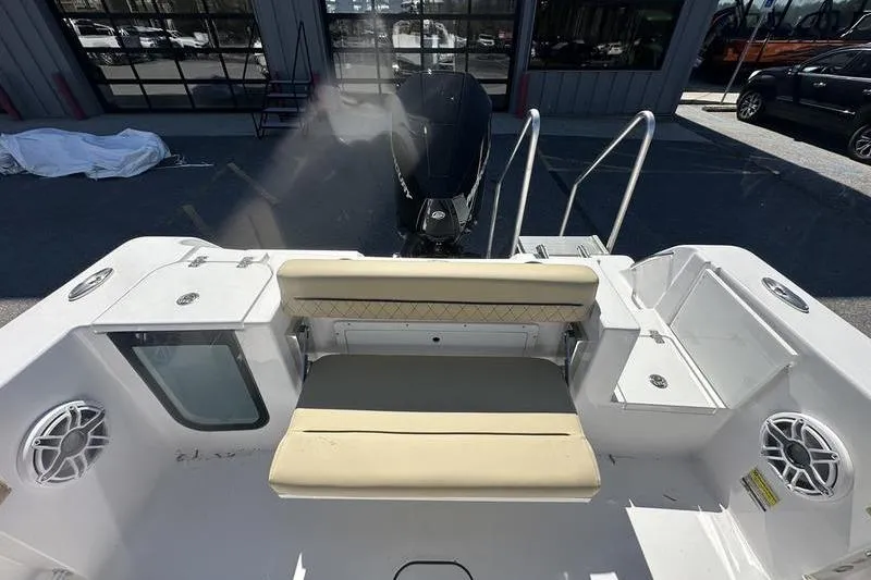 Slide: The Image of 2026 Sportsman Open 232 Center Console boat interior with seating and motor view. - 9