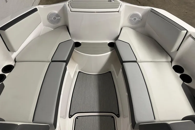 Slide: The Image of 2025 Yamaha Boats AR220 interior with gray seating and cup holders. - 4