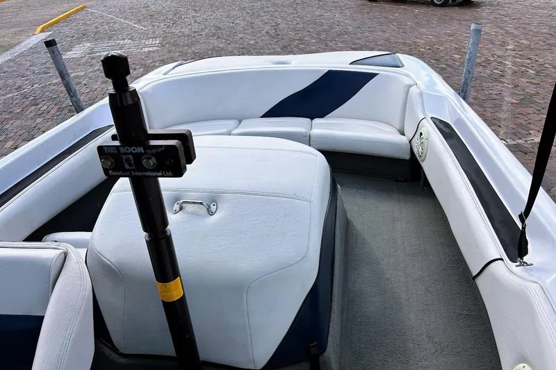 Slide: The Image of 2001 Nautique Air Nautique 210 boat interior with white seating and a boom pole. - 11