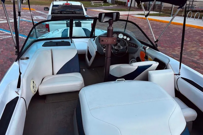 Slide: The Image of 2001 Nautique Air Nautique 210 boat interior with white seating and dashboard. - 12