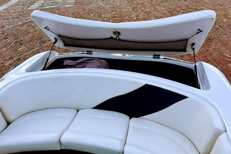 Slide: The Image of Open storage compartment in 2001 Nautique Air Nautique 210 boat with white seating. - 17
