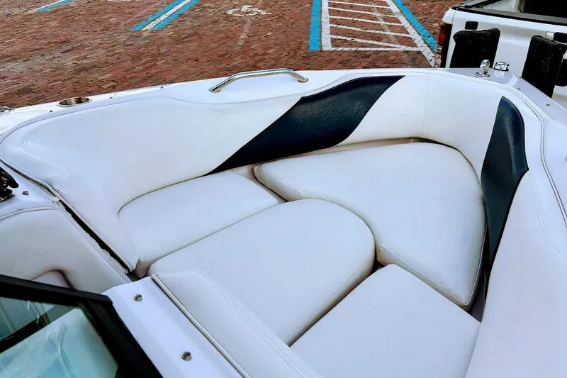 Slide: The Image of 2001 Nautique Air Nautique 210 boat interior with white and navy seating. - 19