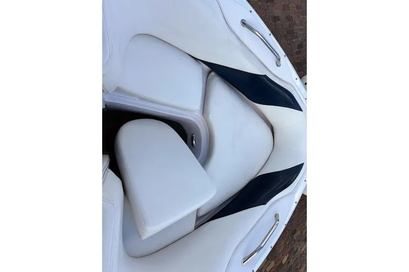 Slide: The Image of 2001 Nautique Air Nautique 210 boat interior with white and navy seating. - 20