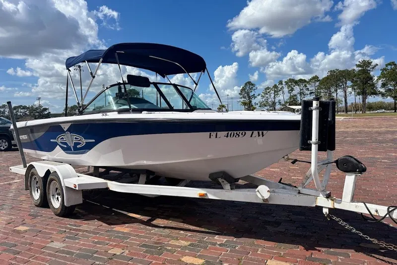 Slide: The Image of 2001 Nautique Air Nautique 210 boat on trailer under blue sky. - 37