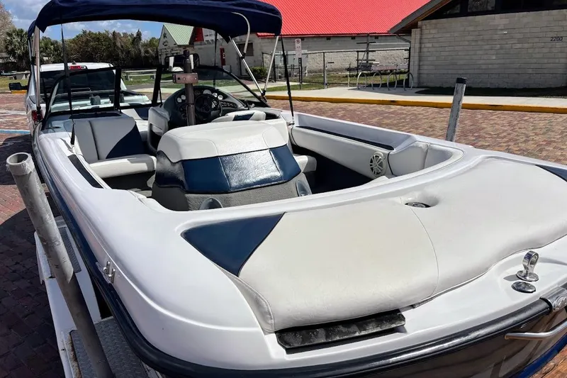 Slide: The Image of 2001 Nautique Air Nautique 210 boat with white and blue interior, parked outdoors. - 8