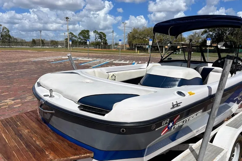 Slide: The Image of 2001 Nautique Air Nautique 210 boat on trailer, parked in sunny outdoor setting. - 9