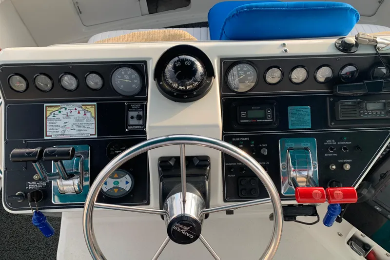 Slide: The Image of Control panel of a 1994 Carver 440 Aft Cabin Motor Yacht with steering wheel and gauges. - 12