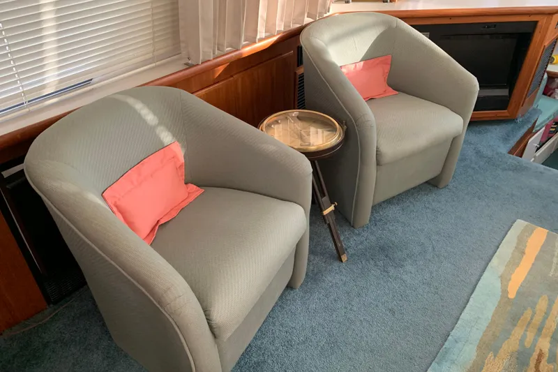 Slide: The Image of Interior of 1994 Carver 440 Aft Cabin Motor Yacht with two armchairs and a small table. - 16