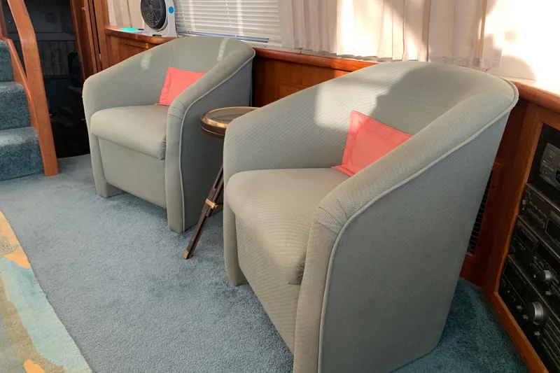 Slide: The Image of Interior of 1994 Carver 440 Aft Cabin Motor Yacht with two armchairs and a side table. - 18