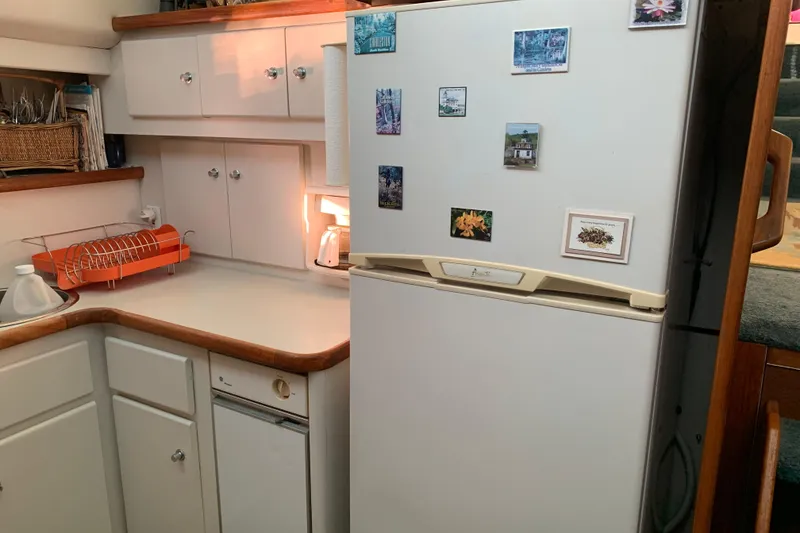 Slide: The Image of Compact kitchen in 1994 Carver 440 Aft Cabin Motor Yacht with fridge and cabinets. - 21