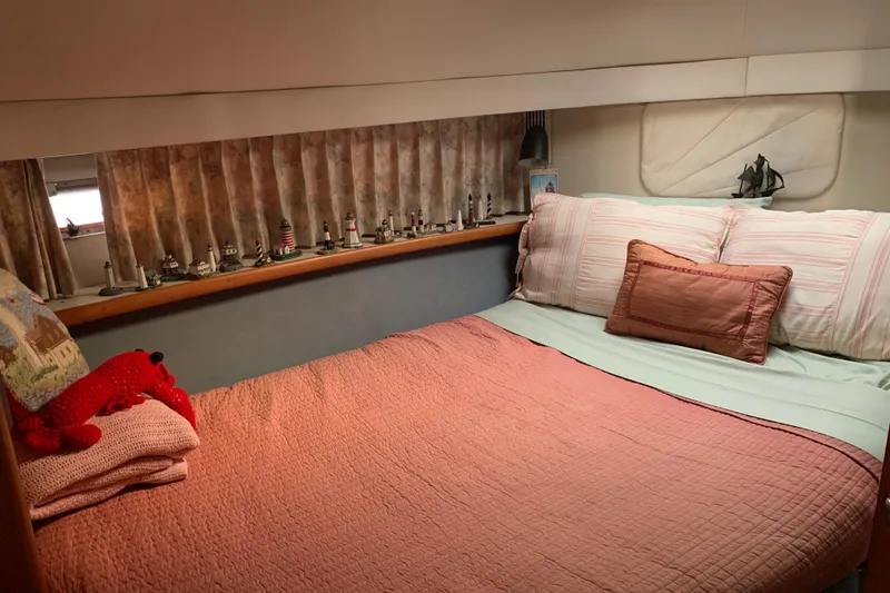 Slide: The Image of Cozy bedroom in 1994 Carver 440 Aft Cabin Motor Yacht with nautical decor. - 25