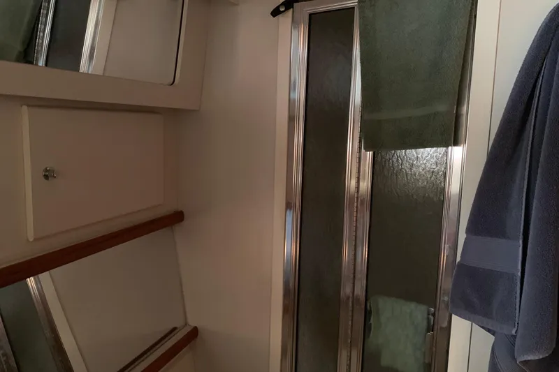 Slide: The Image of Bathroom interior of 1994 Carver 440 Aft Cabin Motor Yacht with shower and towels. - 27
