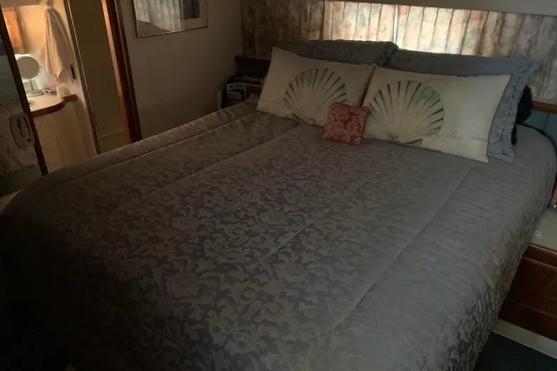 Slide: The Image of Cozy bedroom in 1994 Carver 440 Aft Cabin Motor Yacht with elegant bedding. - 29