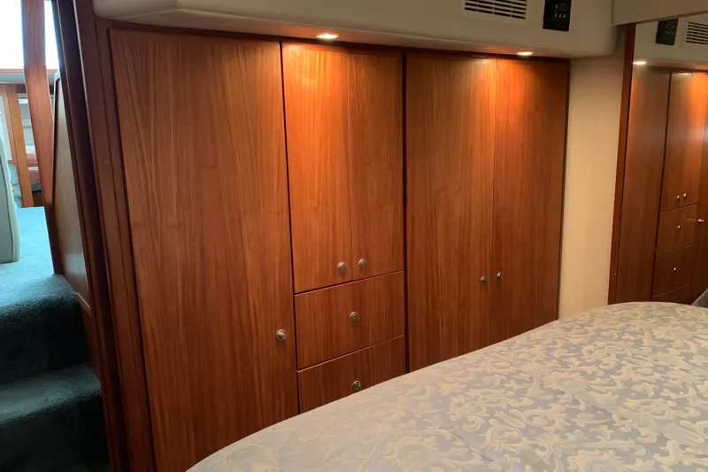 Slide: The Image of Interior of 1994 Carver 440 Aft Cabin Motor Yacht with wooden cabinetry and bed. - 30